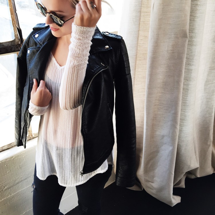 A blonde woman is wearing a take two stretch knit jacket by StyleSaint.