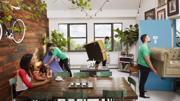 MakeSpace movers and drivers picking up furniture before packing it into a truck and moving it to an affordable temperature-controlled storage facility