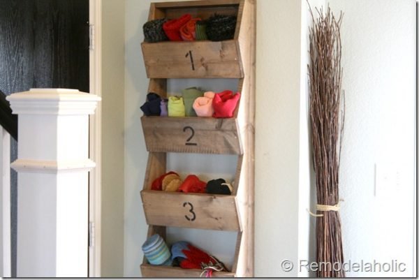 diy glove, scarf, hat, and shoe organizer mounted to a house's entryway wall
