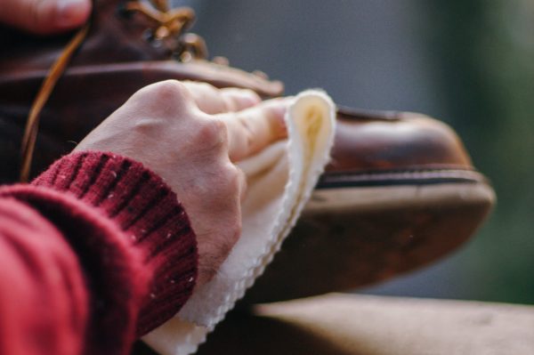 rubbing a leather boot with a cleaning cloth is an easy way to clean boots