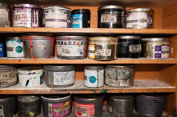 paint cans on four workshop shelves