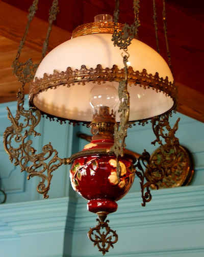 a delicate chandelier hangs from the ceiling