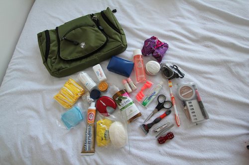 toiletries splayed out on a bed