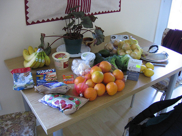 a pile of groceries on a kitchen table