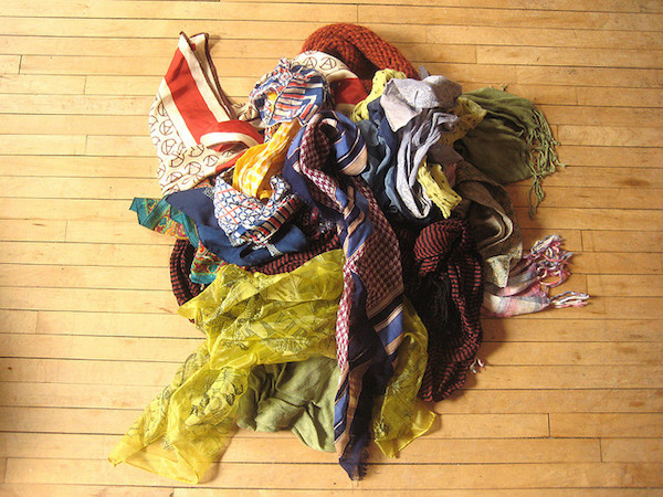 A collection of chic women's scarves on a wooden floor