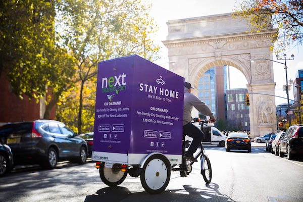 a man rides a bike and hauls laundry in the streets of manhattan