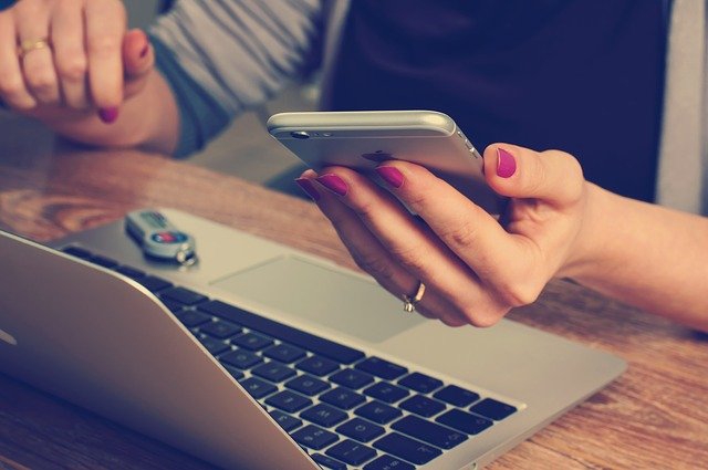 A woman picking up her phone.