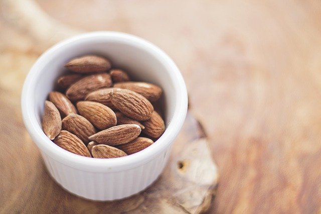 a cup full of raw almonds