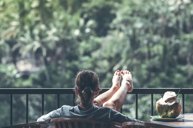 A woman sitting with her feet up in the balcony