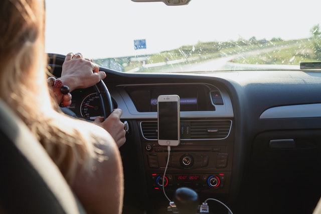A woman driving on a freeway.