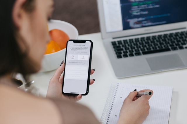A hand making lists using an app