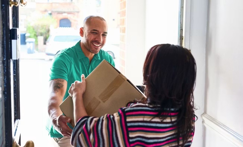 Clutter team member delivering a package to a customer at their door